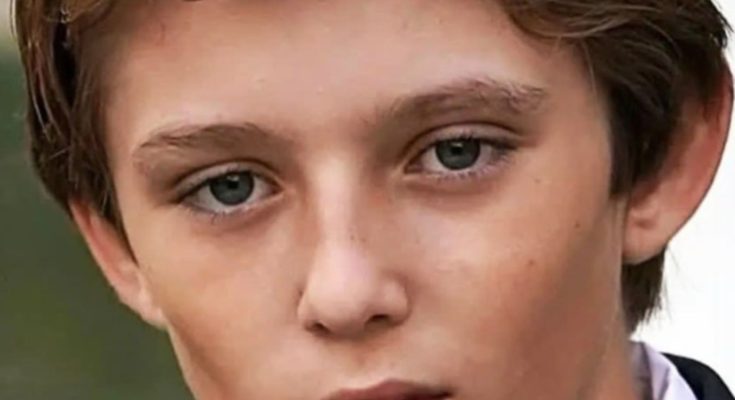 Barron Trump standing reserved at public event