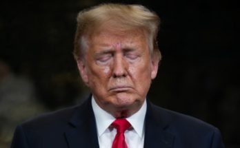 Donald Trump standing quietly in Washington