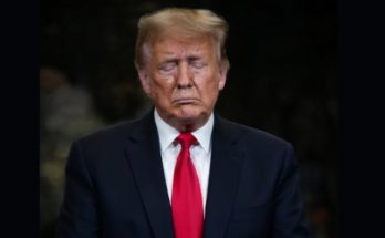 Donald Trump standing quietly in Washington