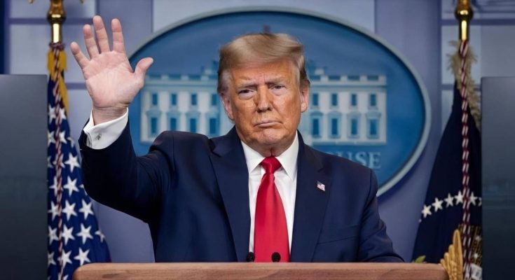 Trump waving from presidential podium