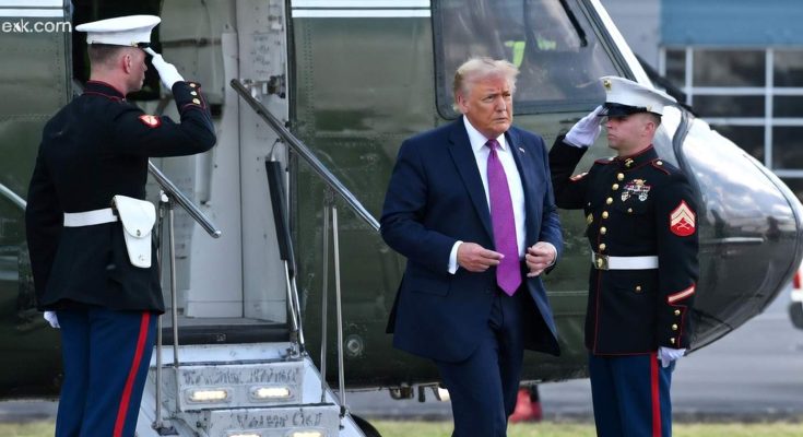 Donald Trump exiting helicopter with Marine honor guard