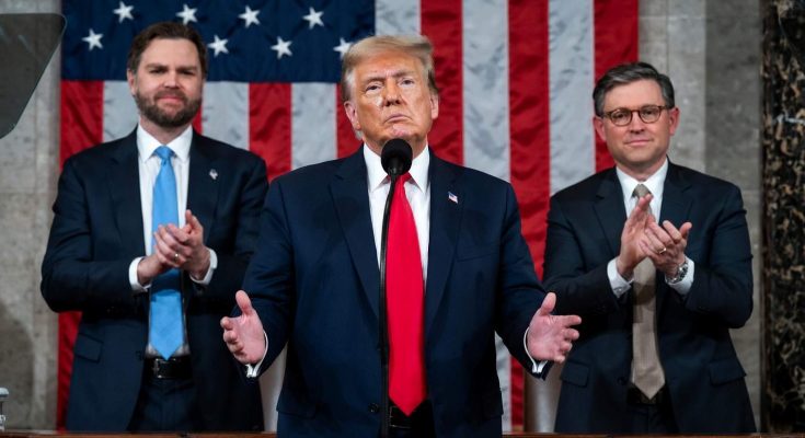 Donald Trump speaking at podium with American flag