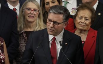 Congressman speaking at podium with colleagues