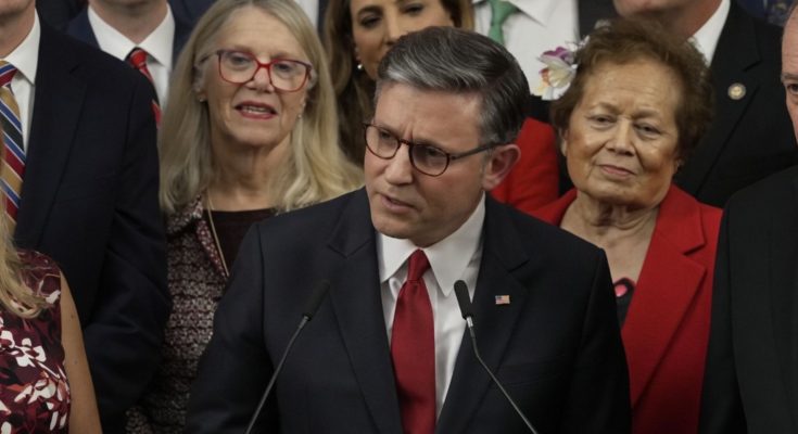 Congressman speaking at podium with colleagues