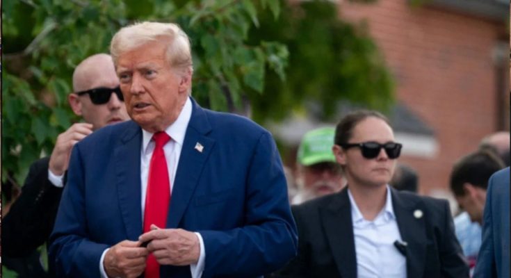 Donald Trump walking outdoors in suit