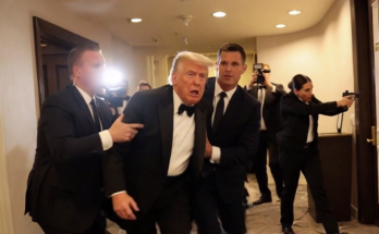 trump in tuxedo being escorted by security personnel amid chaos