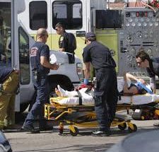 Paramedics loading patient on stretcher