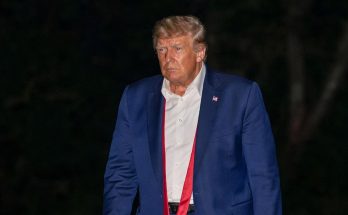 Trump walking with skateboard at night