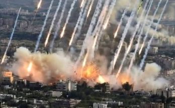 explosions and smoke over city during intense bombardment