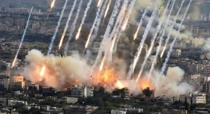 explosions and smoke over city during intense bombardment