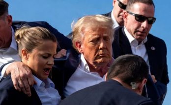 Donald Trump escorted by security