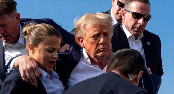 Donald Trump escorted by security