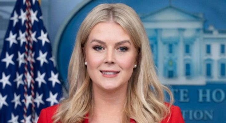 Pam Bondi smiling in red jacket