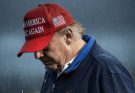 Donald Trump in rain MAGA hat