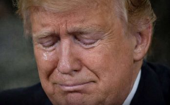 close-up portrait of Donald Trump with eyes closed and visible tear on cheek during