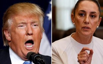 donald Trump speaking into microphone beside a woman in white suit gesturing during a