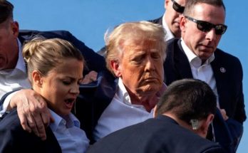 Donald Trump escorted by security