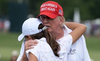Trump hugs young woman on golf course