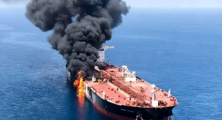 Burning oil tanker ship at sea
