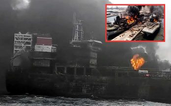 burning ship in harbor with thick smoke and flames