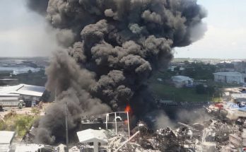 Massive explosion with black smoke over buildings