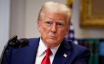 Donald Trump at podium with serious expression