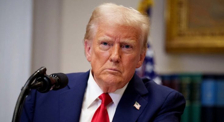 Donald Trump at podium with serious expression