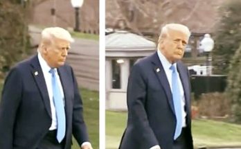 man in suit walking outside, expression serious, daytime setting