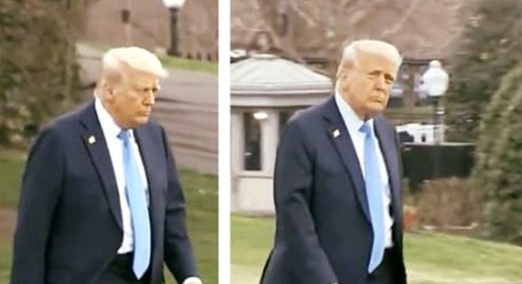 man in suit walking outside, expression serious, daytime setting