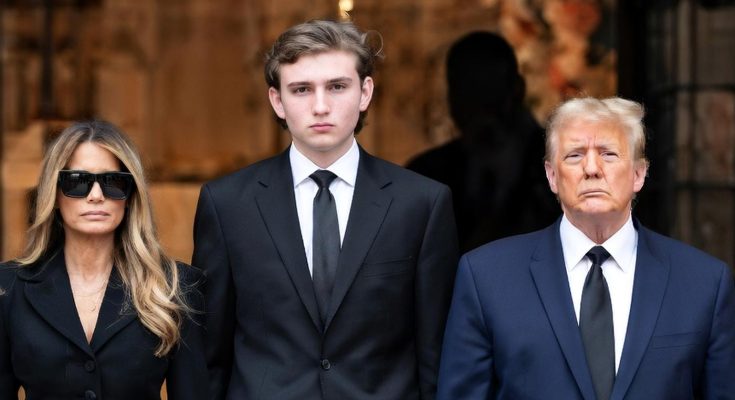 donald Trump, Melania Trump, and Barron Trump in formal black attire standing solemnly