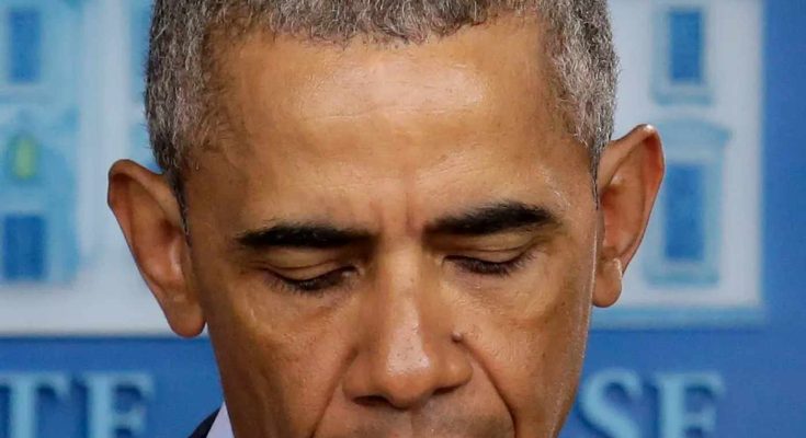 former President Barack Obama looking down with eyes closed at a White House press