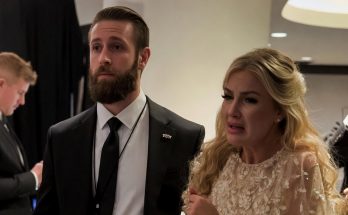 Emotional woman in evening gown with suited security at event