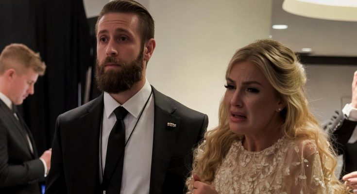Emotional woman in evening gown with suited security at event