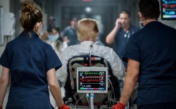 medical team rushing patient on stretcher in busy hospital corridor