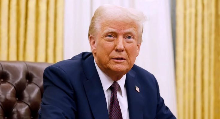 former President Donald Trump seated in a brown leather chair, wearing a dark suit and