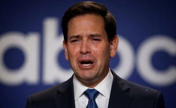 Emotional man in suit crying during speech