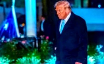 Donald Trump walking outdoors at night