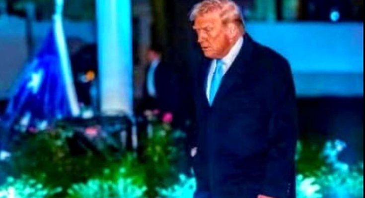 Donald Trump walking outdoors at night