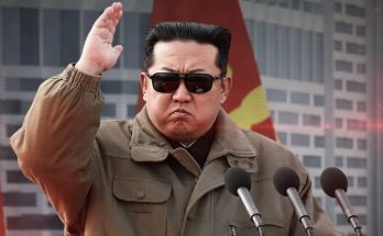 Kim Jong-un waving salute with flag