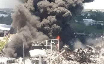 massive smoke cloud from industrial fire near coastline