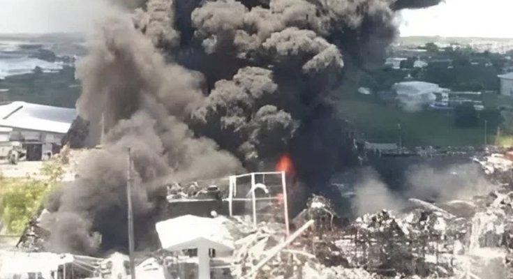 massive smoke cloud from industrial fire near coastline